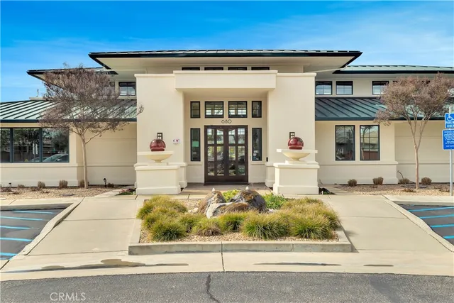 a living room with furniture a flat screen tv and a floor to ceiling window