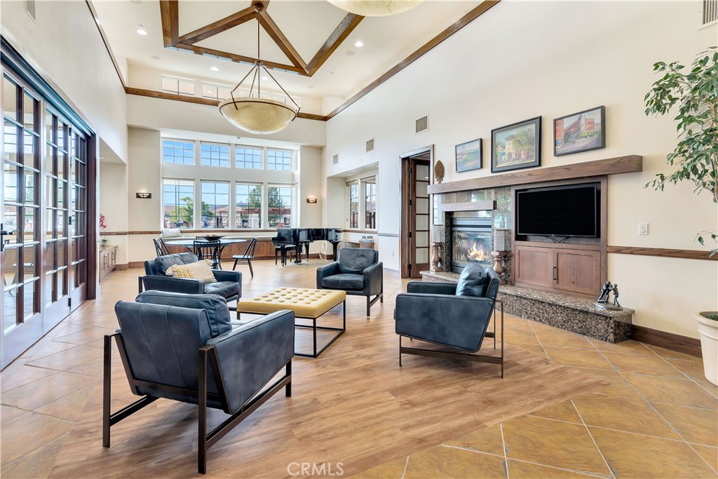 2757 Traditions Loop Paso Robles, CA 93446 - Photo 46 of 58 a living room with furniture a flat screen tv and a floor to ceiling window