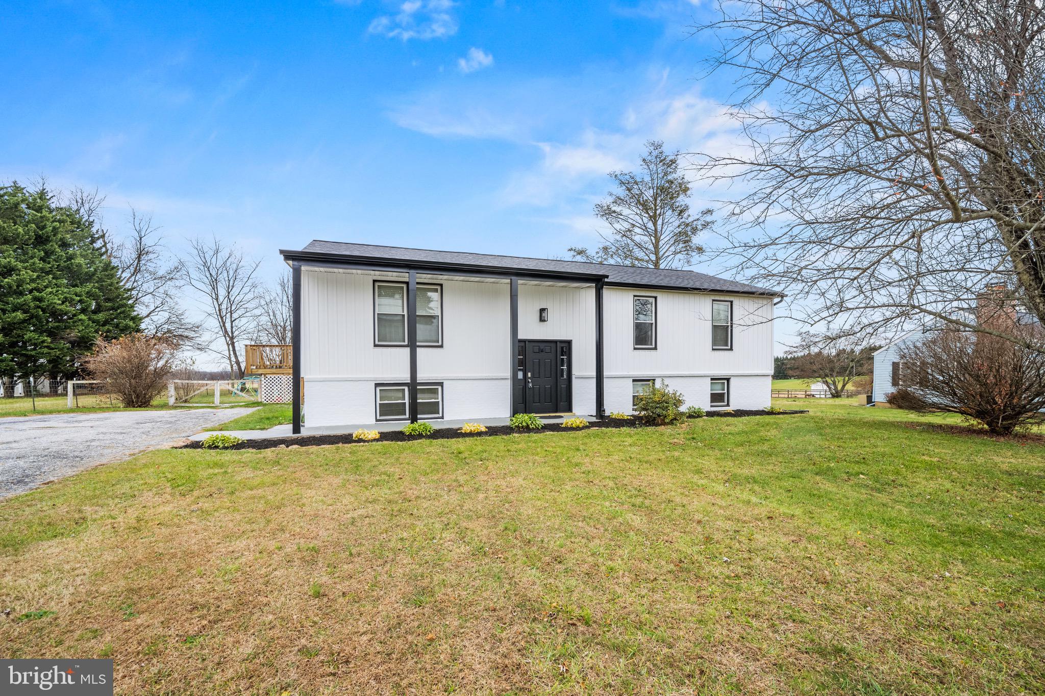 a front view of house with yard and trees