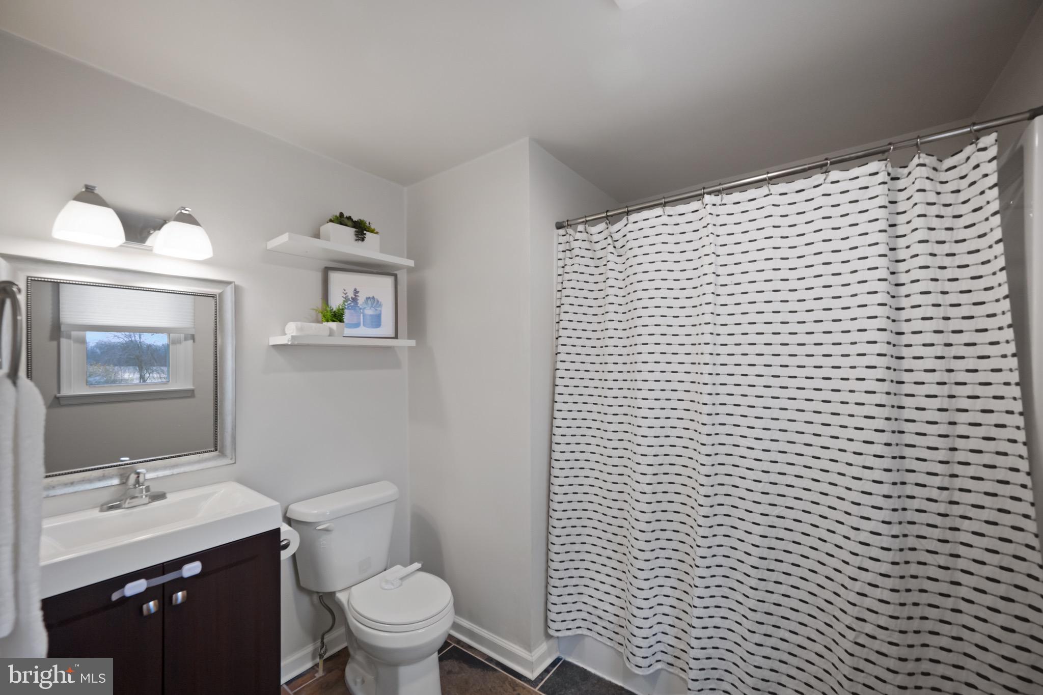 15915 Trenton Road Upperco, MD 21155 - Photo 21 of 41 a bathroom with a granite countertop toilet a sink a mirror and vanity
