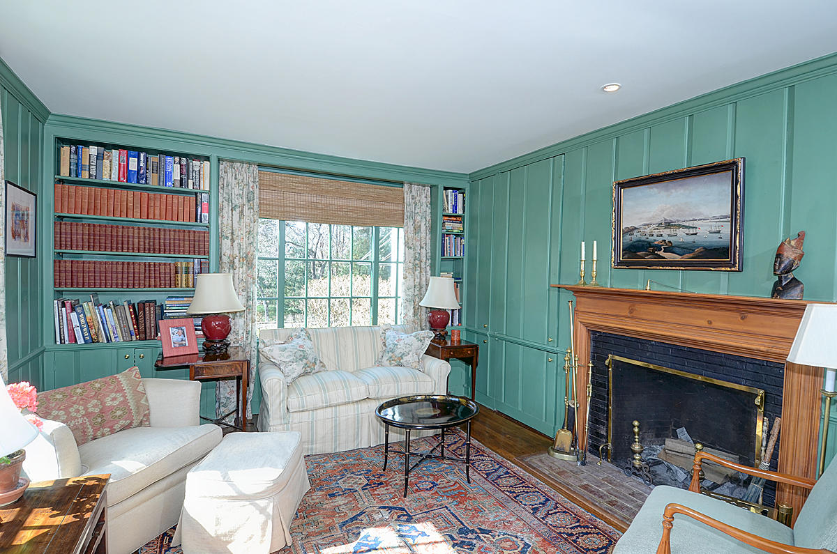 1062 Ponus Ridge Road New Canaan, CT 06840 - Photo 11 of 31 a living room with furniture a flat screen tv and a fireplace