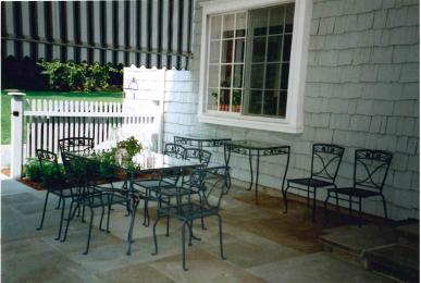 1062 Ponus Ridge Road New Canaan, CT 06840 - Photo 29 of 31 a view of a chair and table in the back yard of the house