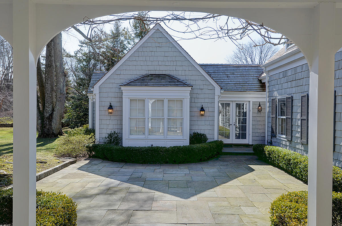 1062 Ponus Ridge Road New Canaan, CT 06840 - Photo 3 of 31 a front view of a house with garden