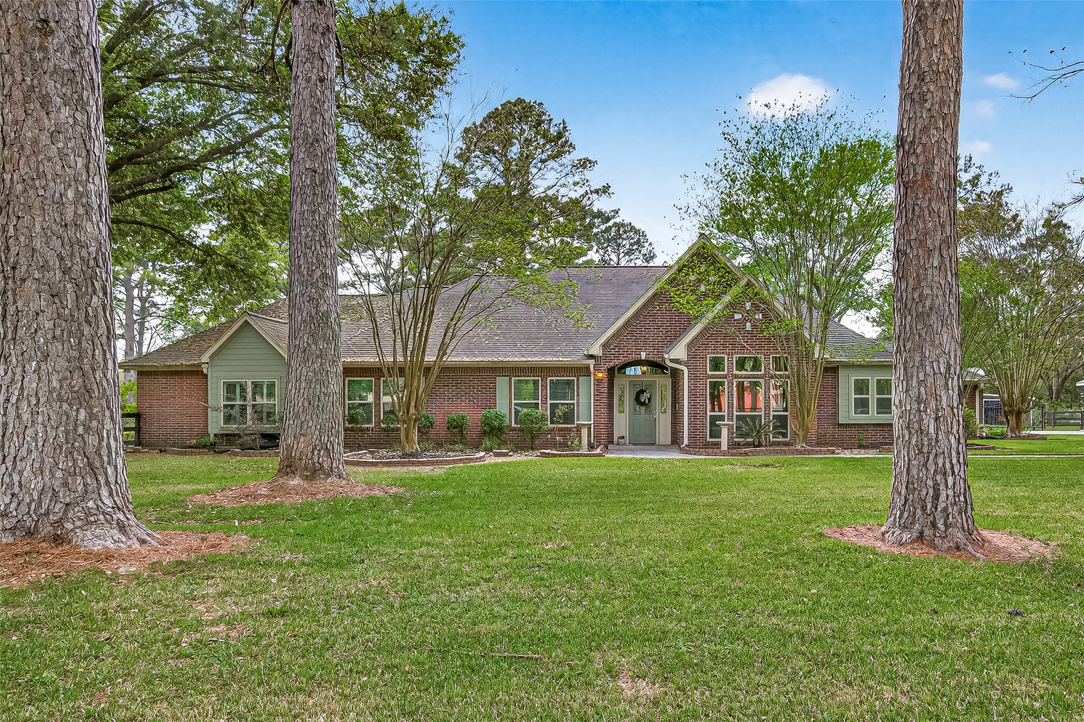 17603 Bending Cypress Road Cypress, TX 77429 - Photo 1 of 43 Charming brick home set amidst an expansive lawn with mature trees, offering a serene and private setting.