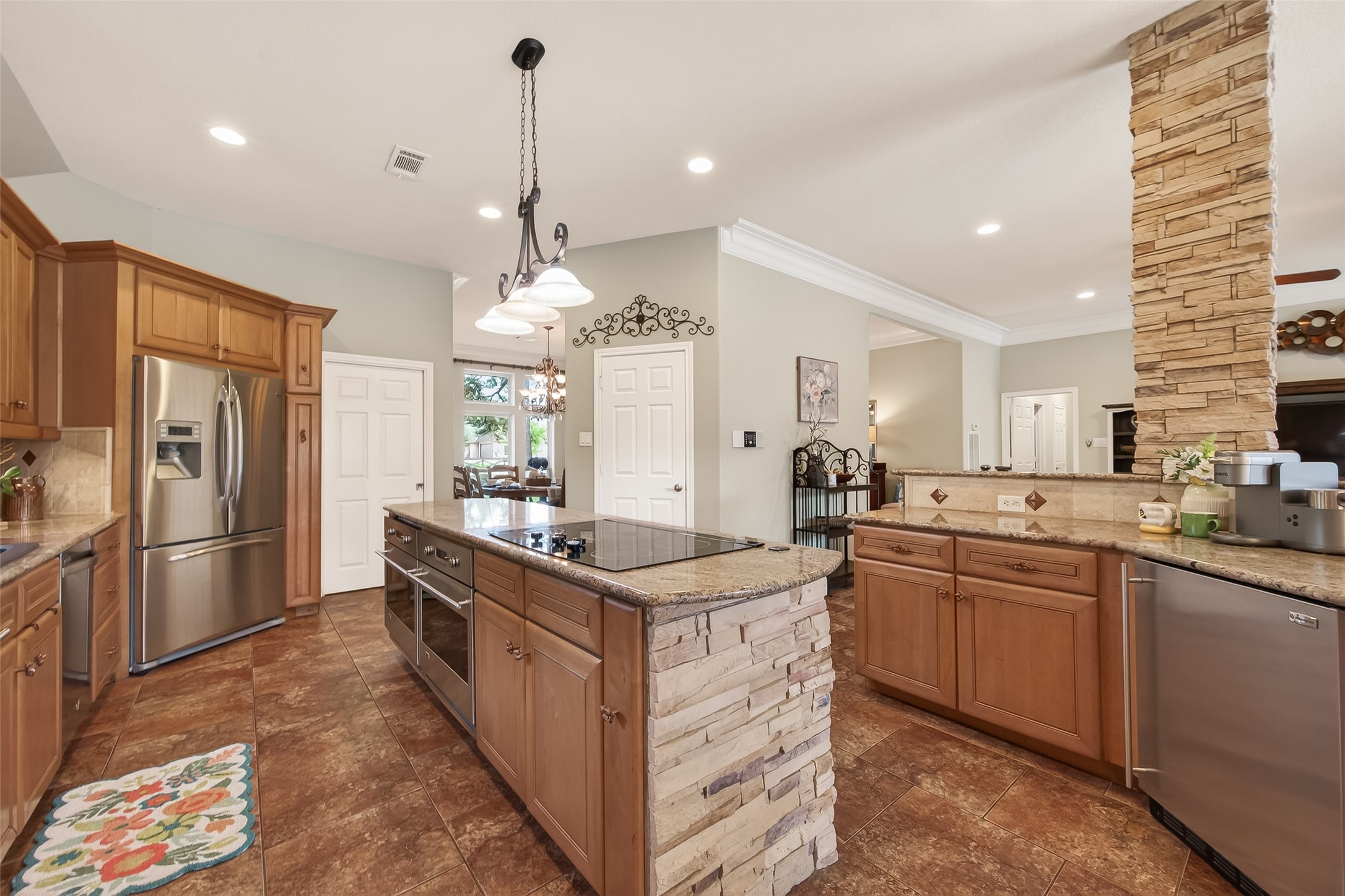 17603 Bending Cypress Road Cypress, TX 77429 - Photo 15 of 43 The stone accents and tile flooring add a rustic touch, while the lighting provides a cozy ambiance.