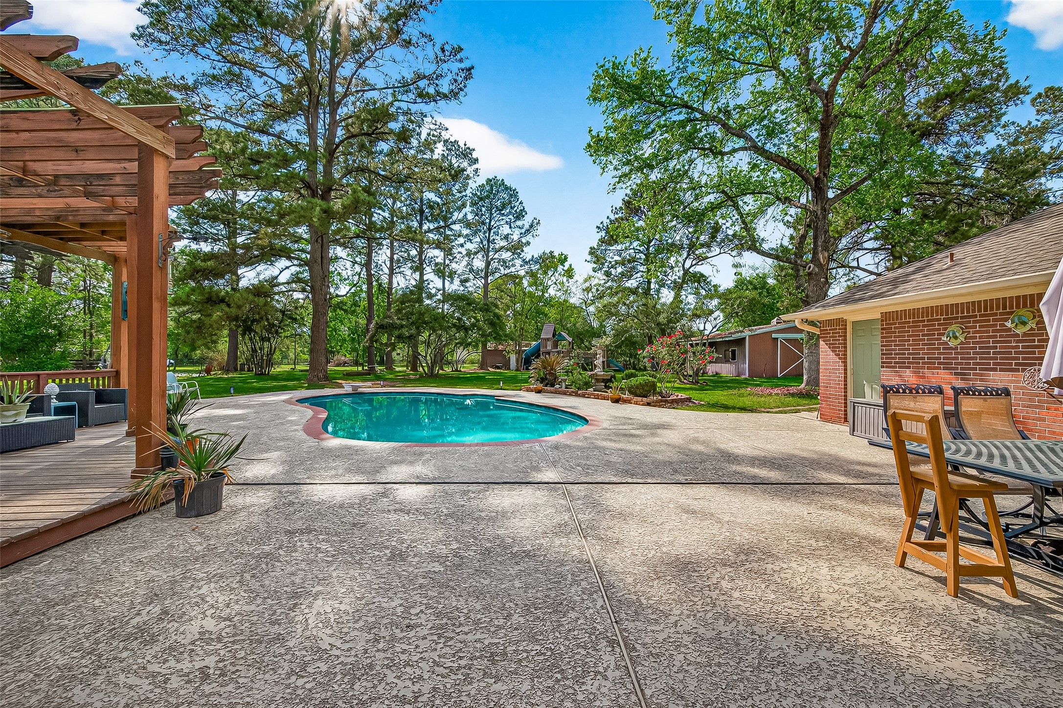 17603 Bending Cypress Road Cypress, TX 77429 - Photo 34 of 43 The backyard features a spacious patio with a pergola, a swimming pool, and ample seating areas. Surrounded by lbeautiful treed lot - perfect for outdoor relaxation and entertaining.