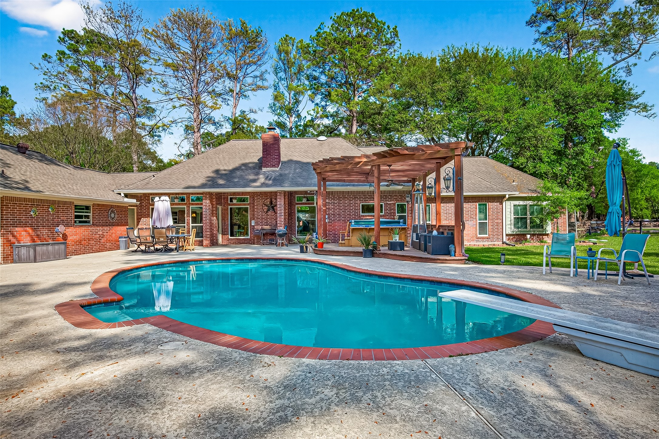17603 Bending Cypress Road Cypress, TX 77429 - Photo 35 of 43 A spacious backyard with beautiful pool and surrounding patio area. There's a pergola with outdoor seating, perfect for relaxation or entertaining. Mature trees add privacy and a serene atmosphere.
