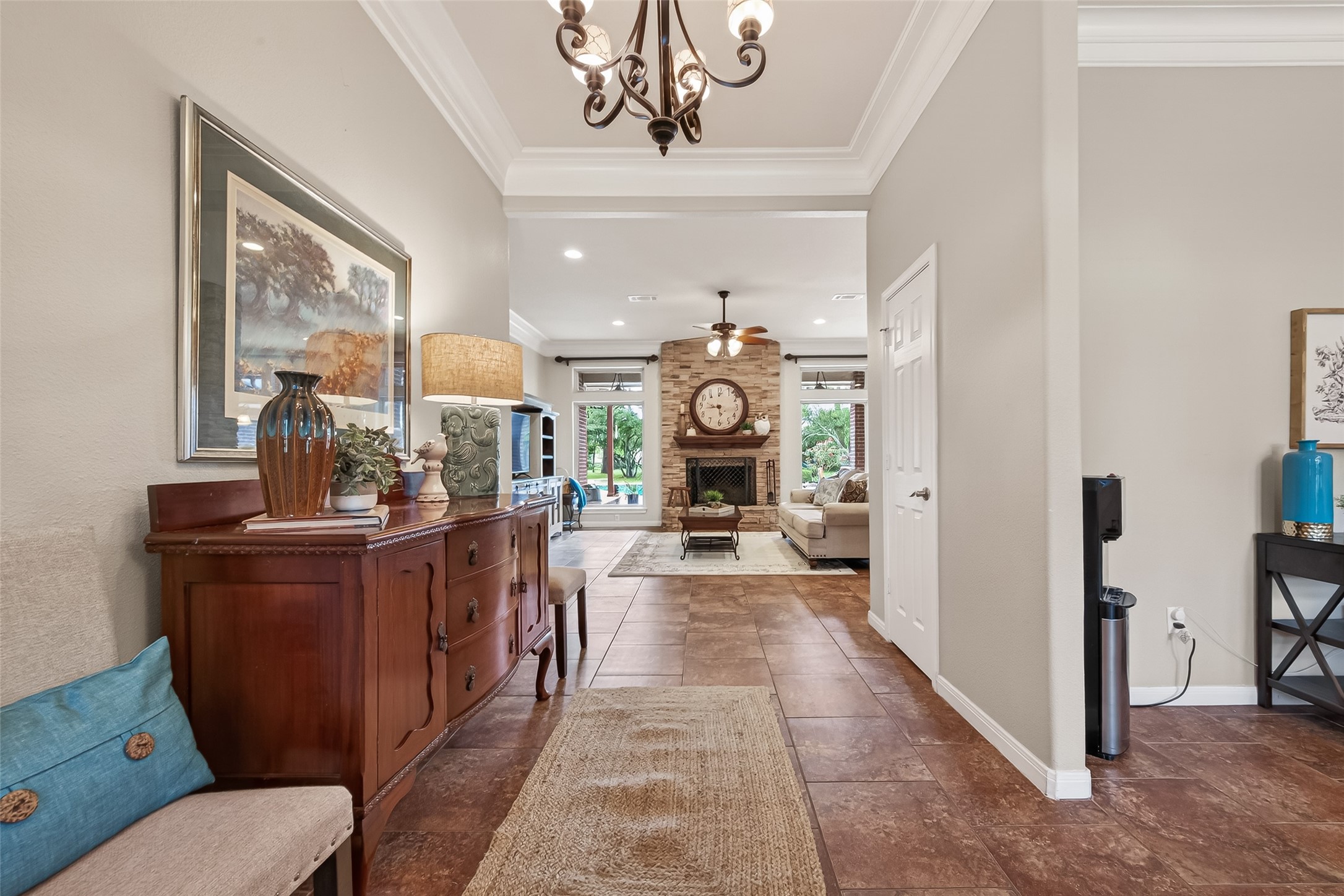 17603 Bending Cypress Road Cypress, TX 77429 - Photo 5 of 43 The inviting entryway features warm tile flooring, elegant crown molding and leads to a cozy living room with a stone fireplace surround and large windows overlooking the backyard pool and pond. The Entryway is open and welcoming..