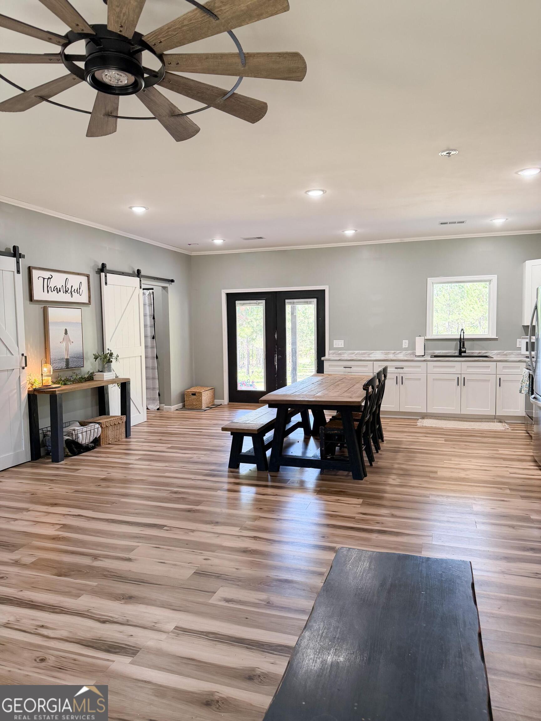 210 St Galilee Road Swainsboro, GA 30401 - Photo 7 of 18 a large room with lots of furniture and a wooden floor
