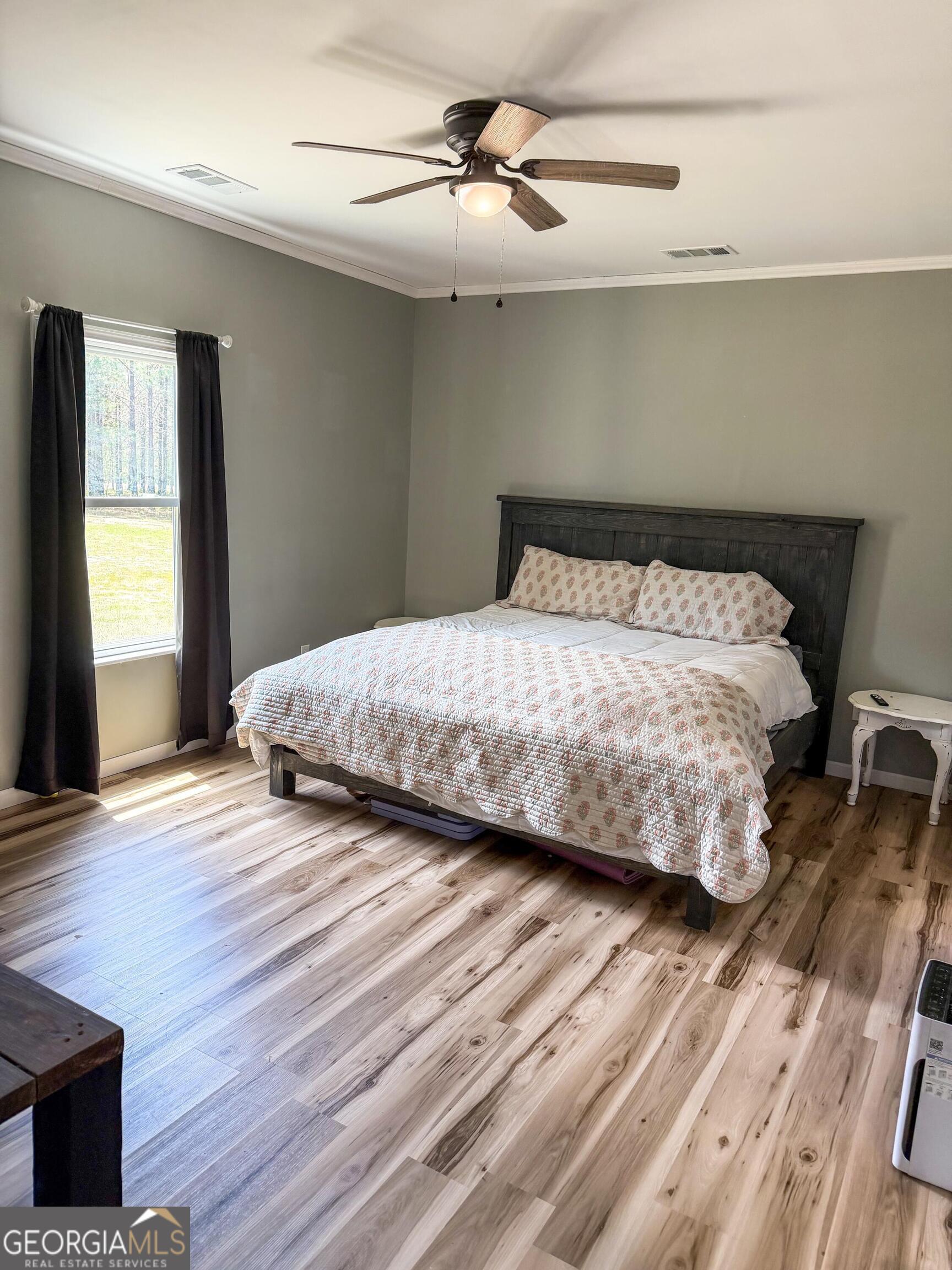210 St Galilee Road Swainsboro, GA 30401 - Photo 9 of 18 a bedroom with a bed and wooden floor