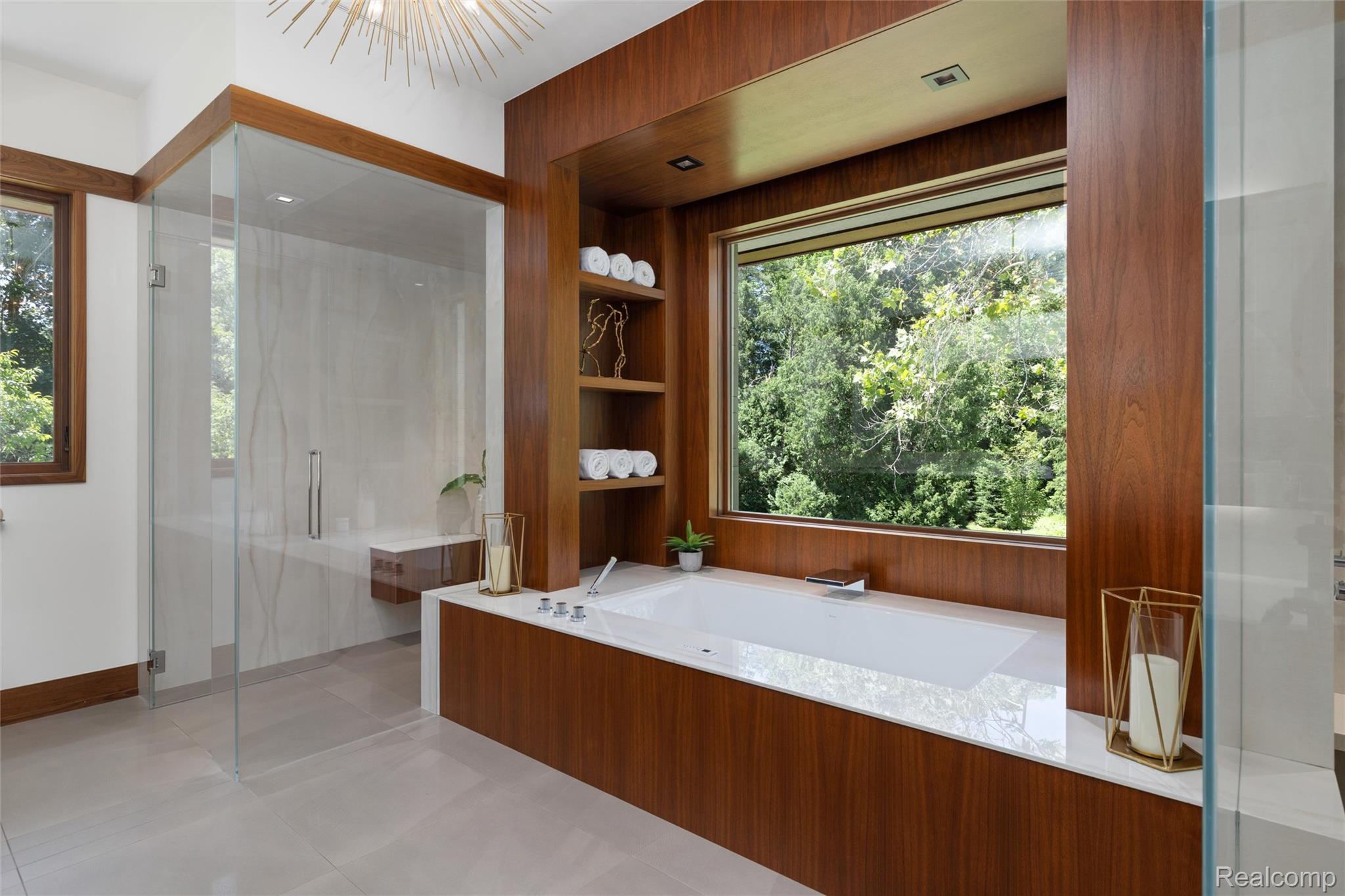 2700 Squirrel Road Bloomfield Hills, MI 48304 - Photo 33 of 83 Modern bathroom with a large soaking tub set into wood-finish paneling, featuring an expansive window with outdoor scenery