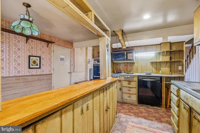 a kitchen with stainless steel appliances granite countertop a stove and cabinets