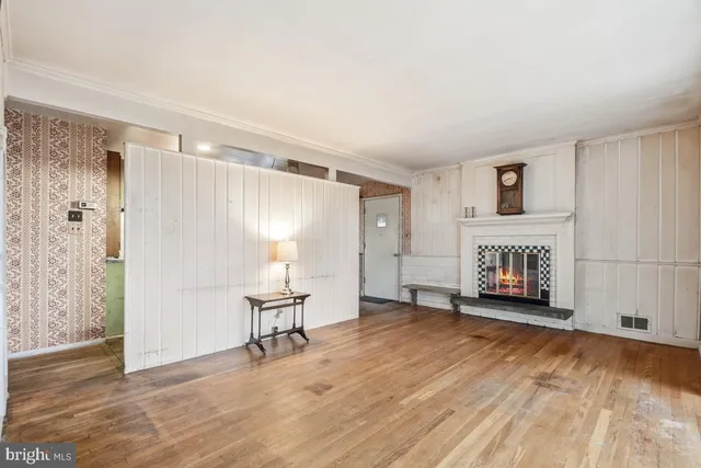 a view of a livingroom with a hardwood and a ceiling fan