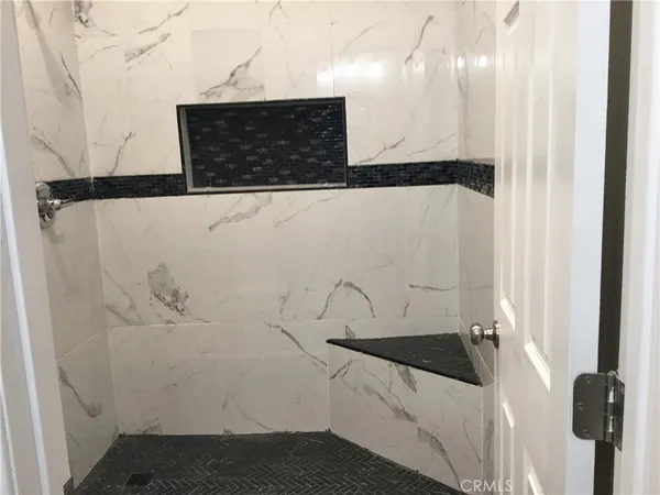 a bathroom with a bathtub and shower