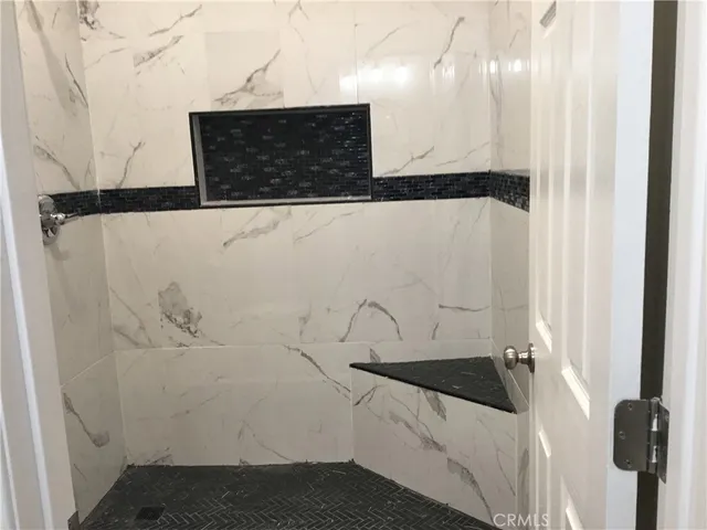 a bathroom with a bathtub and shower