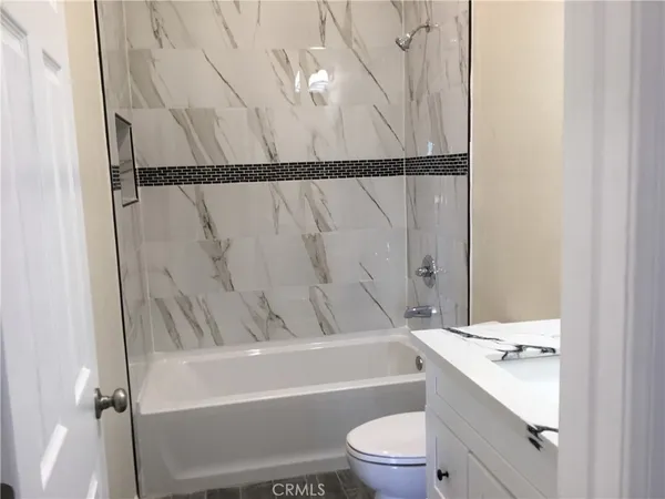 a bathroom with a sink a toilet and a bathtub