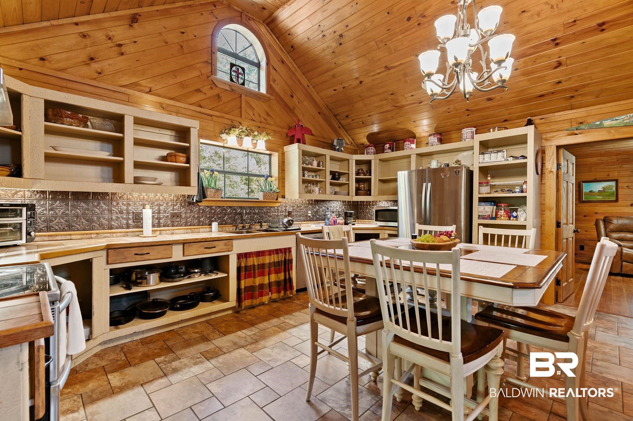 724 Rowell Lane Brewton, AL 36426 - Photo 14 of 40 Kitchen with appliances with stainless steel finishes, wood ceiling, high vaulted ceiling, pendant lighting, and tasteful backsplash