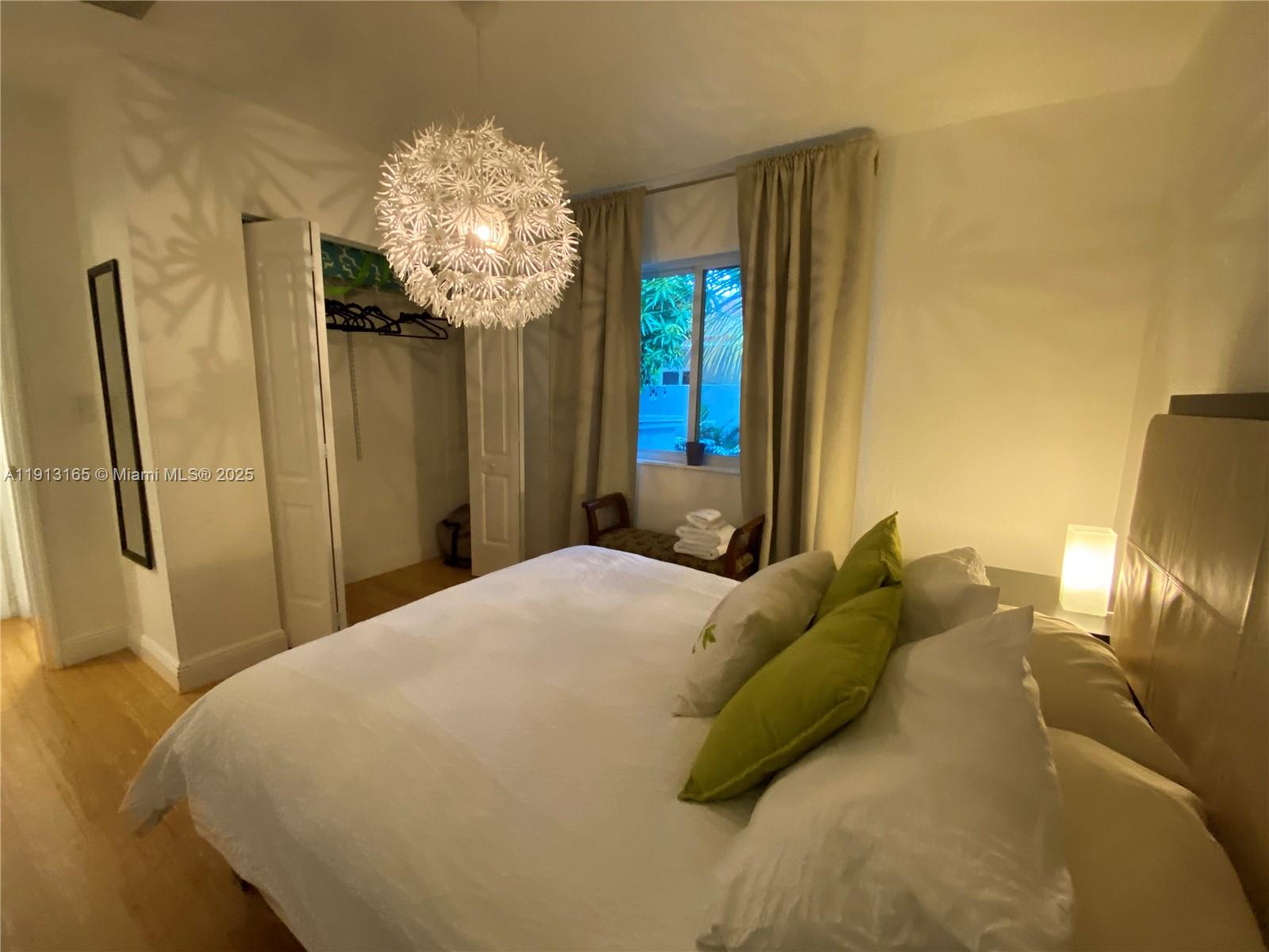 6855 Northeast 5th Avenue, Unit C Miami, FL 33138 - Photo 6 of 13 a bed sitting in a bedroom next to a window