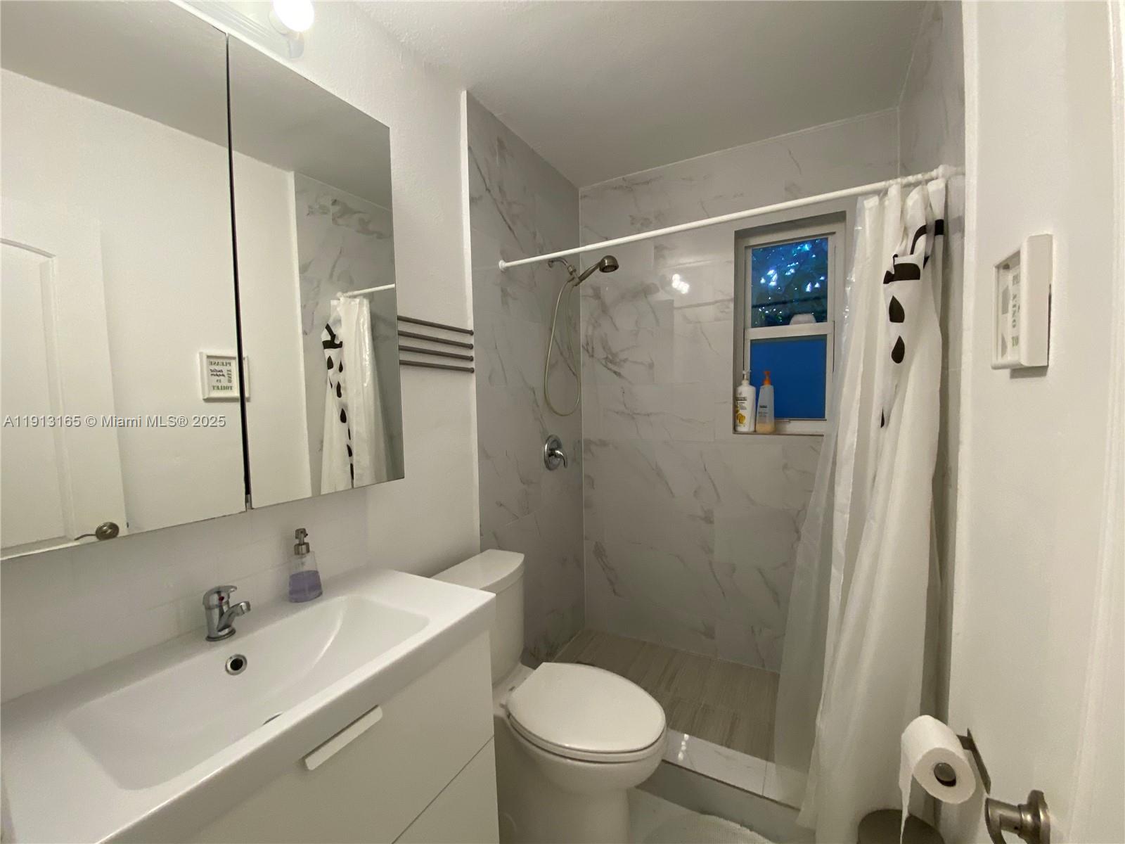 6855 Northeast 5th Avenue, Unit C Miami, FL 33138 - Photo 10 of 13 a bathroom with a sink toilet and shower