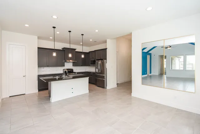 a kitchen with granite countertop a sink and window