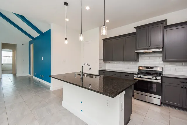 a stove top oven sitting inside of a kitchen