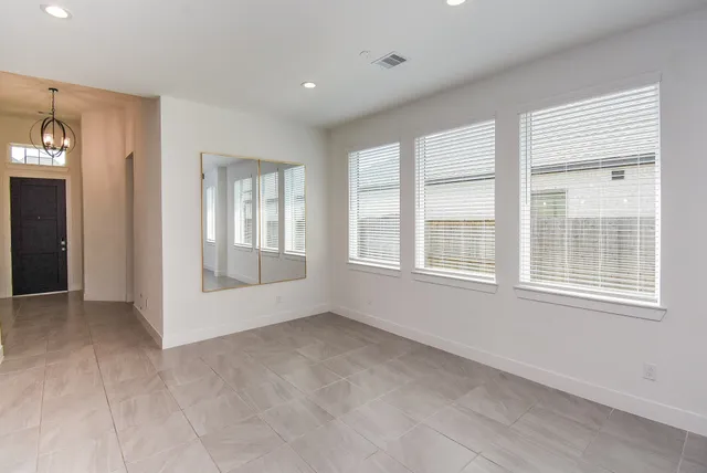 a bathroom with a bathtub shower sink vanity mirror and toilet