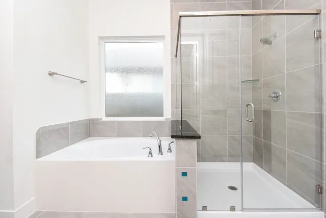 a bathroom with a tub and shower