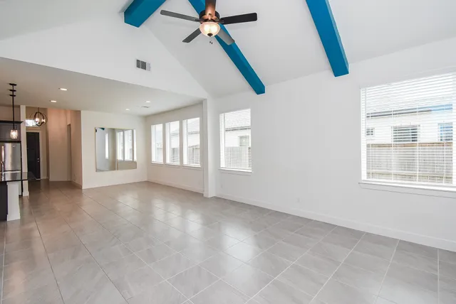 a large room with kitchen view and living room view