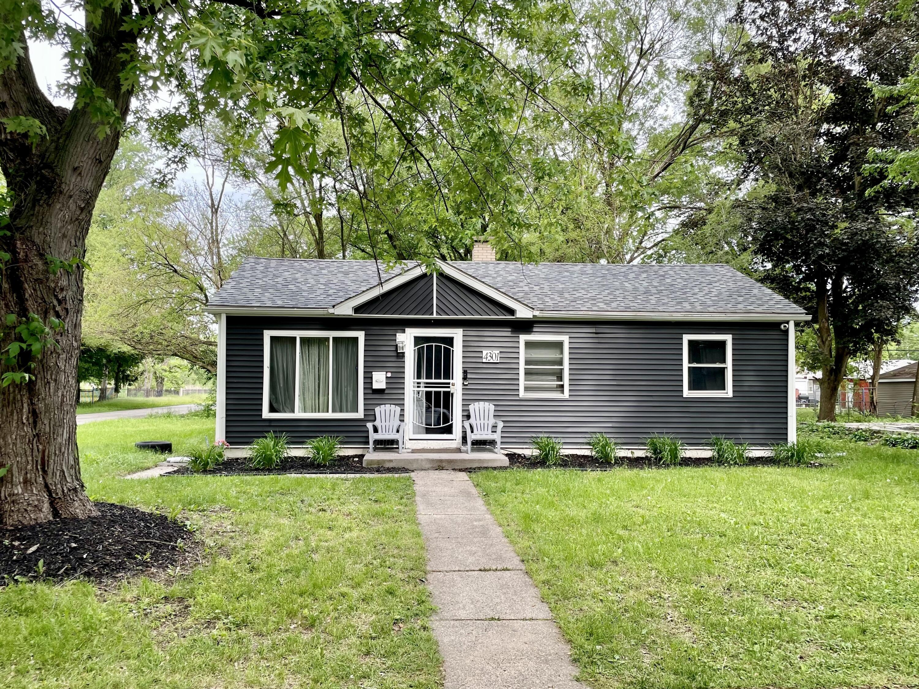 4301 Johnson Street Gary, IN 46408 - Photo 2 of 16 a front view of a house with a yard