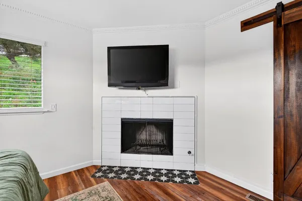 a living room with a fireplace and a flat screen tv