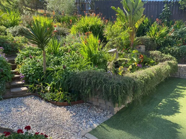 a view of a backyard with wooden fence and a bench