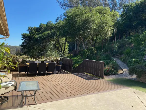 a view of a backyard with sitting area