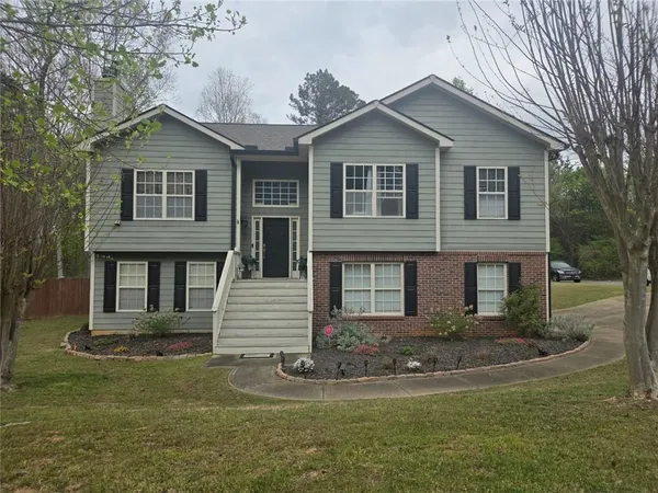 a front view of a house with a yard