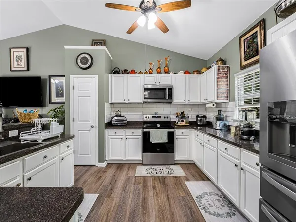 a kitchen with stainless steel appliances a stove a sink and a refrigerator