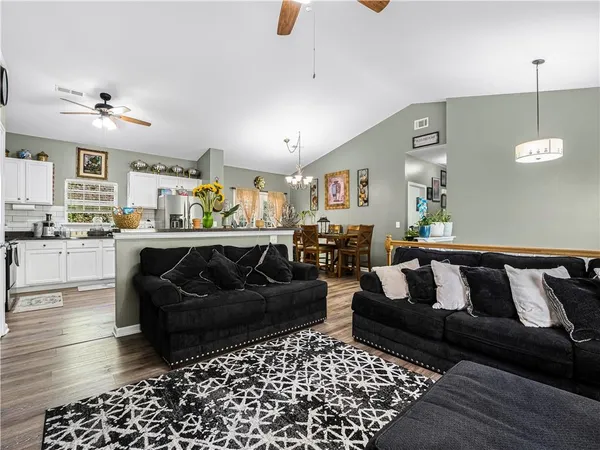 a living room with furniture and wooden floor