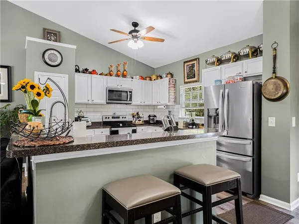a kitchen with a refrigerator and a sink