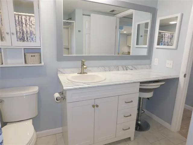 a bathroom with a sink toilet and mirror