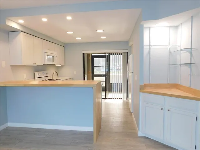 a kitchen with stainless steel appliances granite countertop a refrigerator and sink
