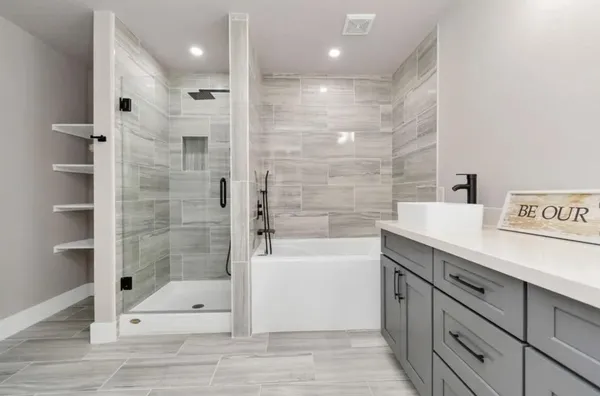 a bathroom with a shower sink and mirror