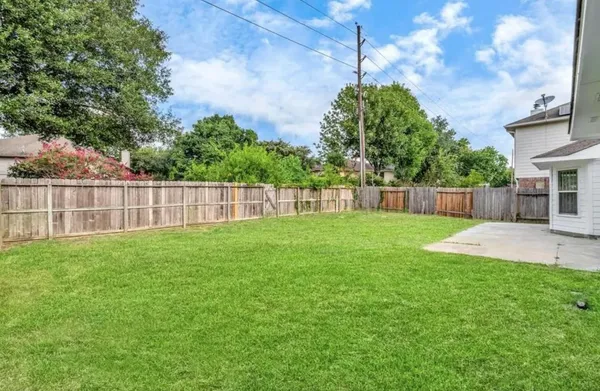 a view of yard with grass and trees