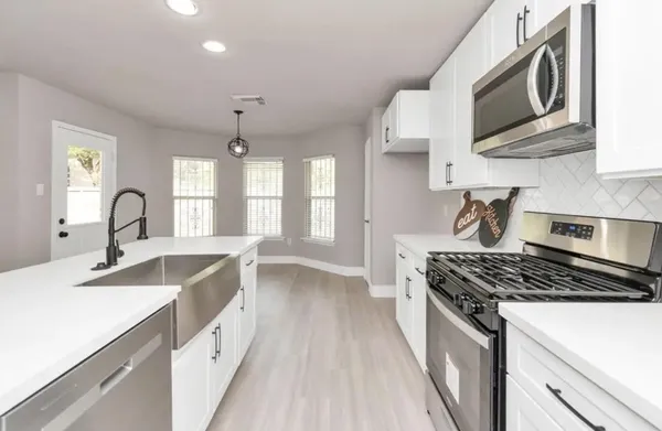 a kitchen that has a sink and a stove