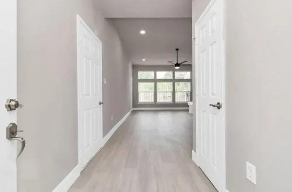 wooden floor in an empty room with a window