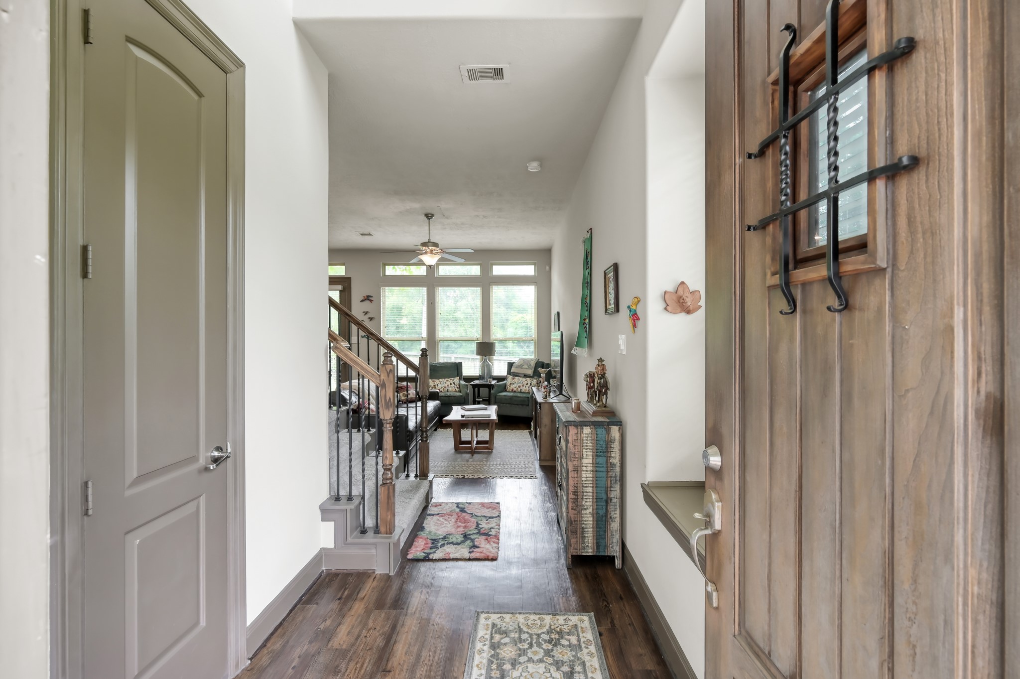 18 Aventura Place Spring, TX 77389 - Photo 2 of 43 a view of a hallway with wooden floor and a living room