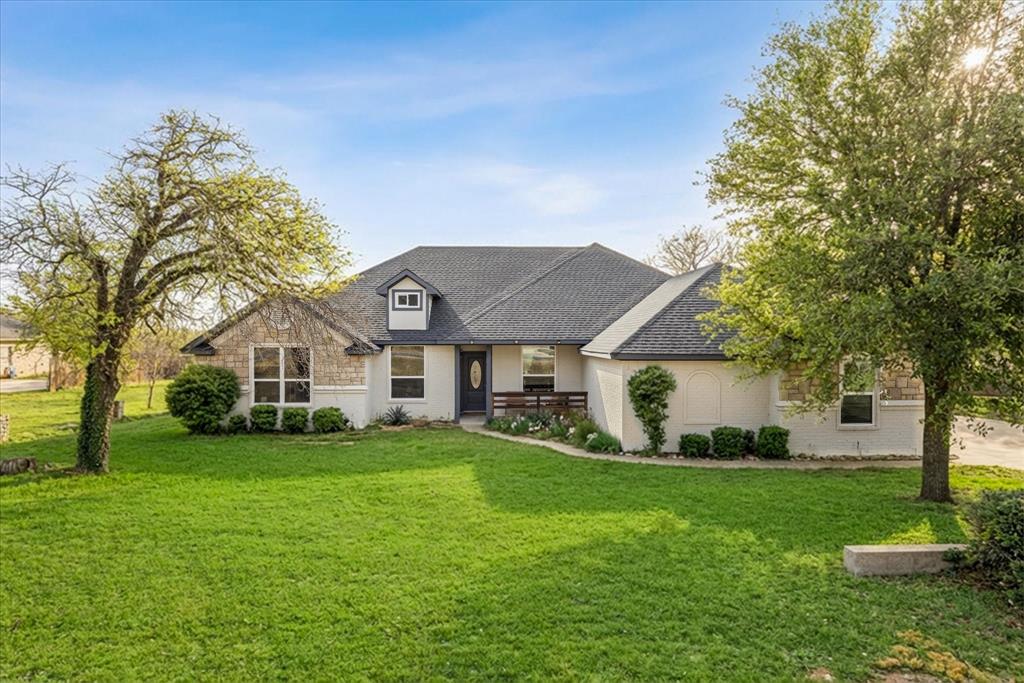 4801 West Wedgefield Road Granbury, TX 76049 - Photo 1 of 40 a front view of a house with a yard