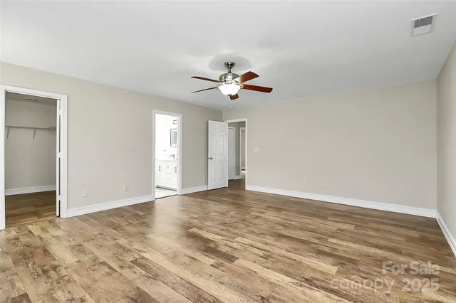 a bathroom with a double vanity sink a toilet and shower