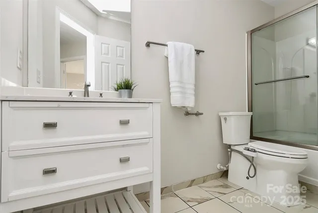 a bathroom with a shower a toilet and a window