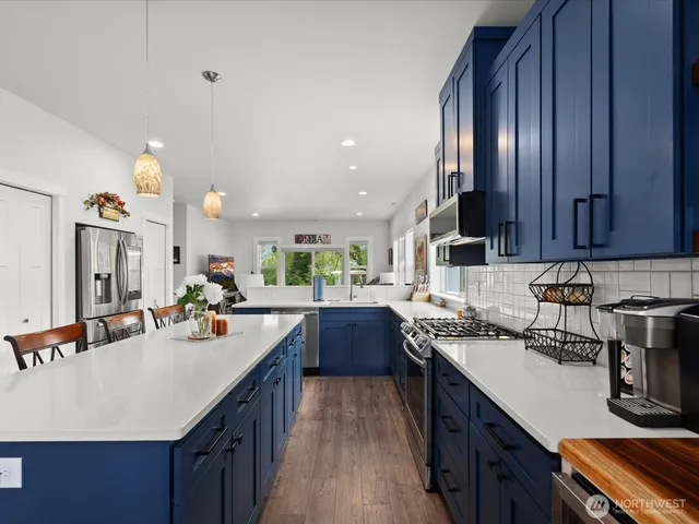 a kitchen with a sink stove and cabinets