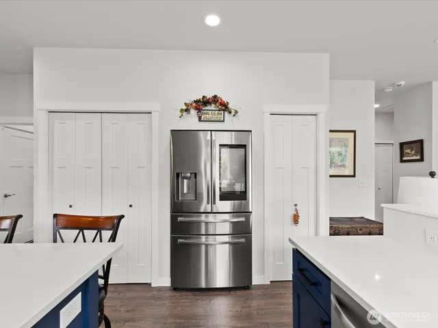 a kitchen with stainless steel appliances a refrigerator and a stove top oven