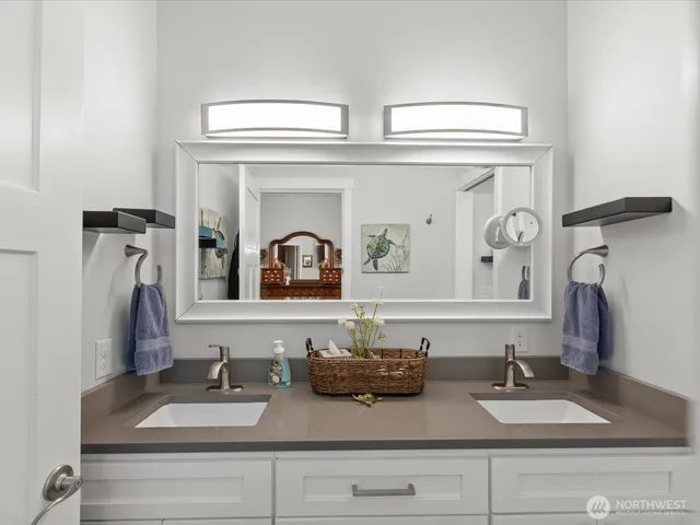 a bedroom with a bed and a potted plant