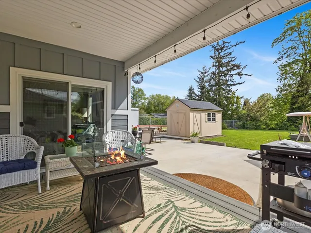 a view of a patio with table and chairs and potted plants